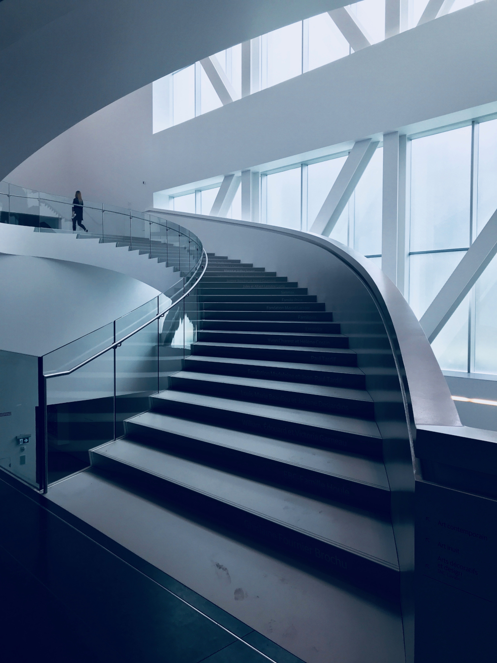 A vertical shot of a modern stairway in a beautiful white building